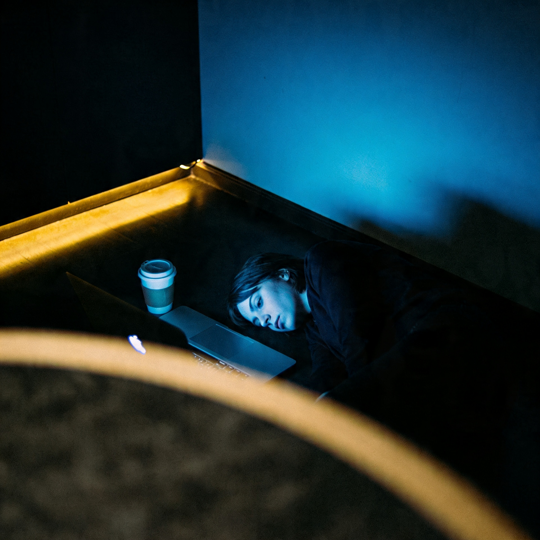 Awake in a dim room, screen light on the ceiling